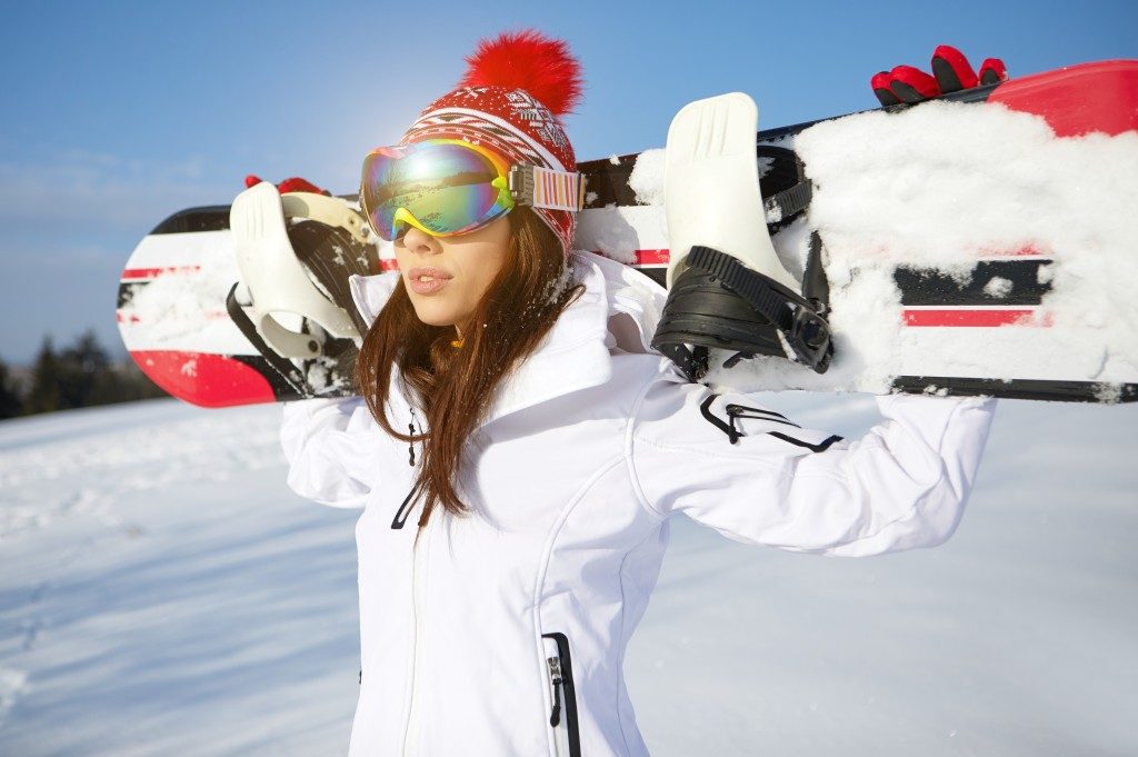 woman wearing a white ski suit and googles