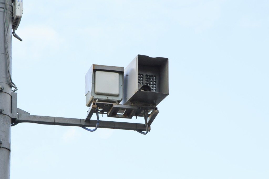 Radar gun attached on a pole to get speed of passing cars