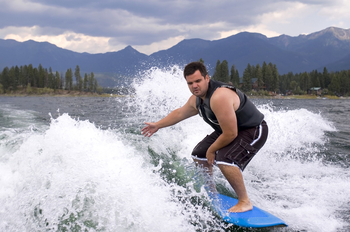 man surfing with a blue surfboard